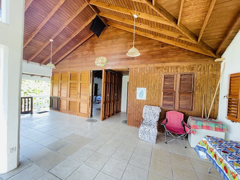 Spacious patio with chairs and wooden facade 